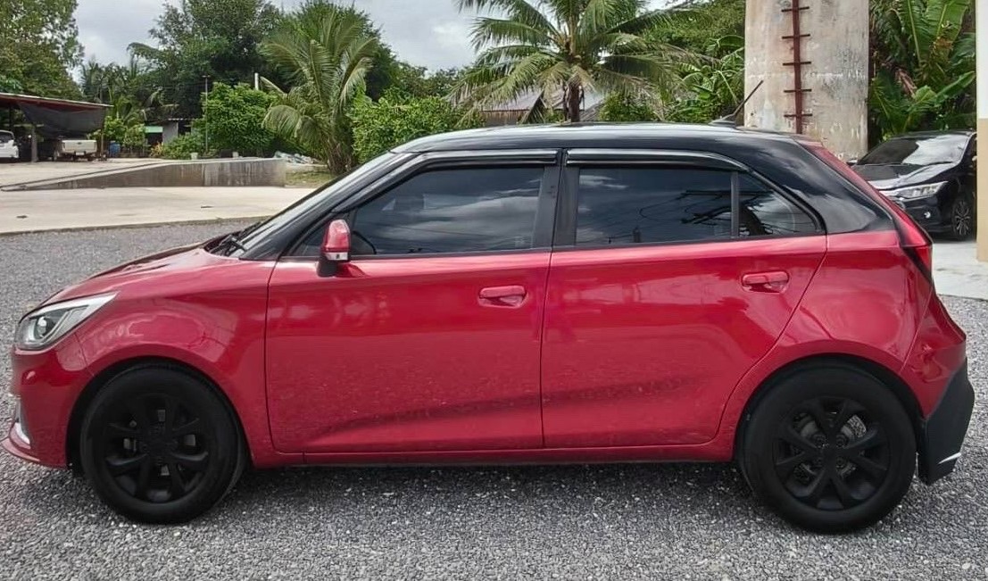 Side view of red 2020 MG 3 rental car in Hua Hin