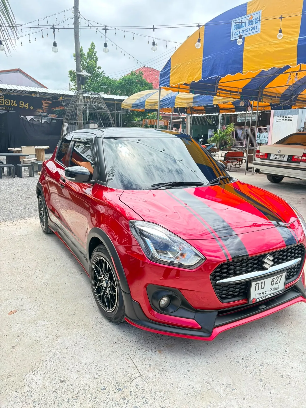 Red 2023 Suzuki Swift GLX rental car in Hua Hin