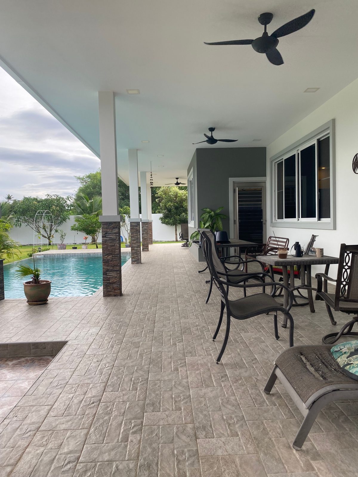 Covered poolside terrace for outdoor dining and relaxation