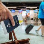 An immigration officer checks a foreign traveller’s passport