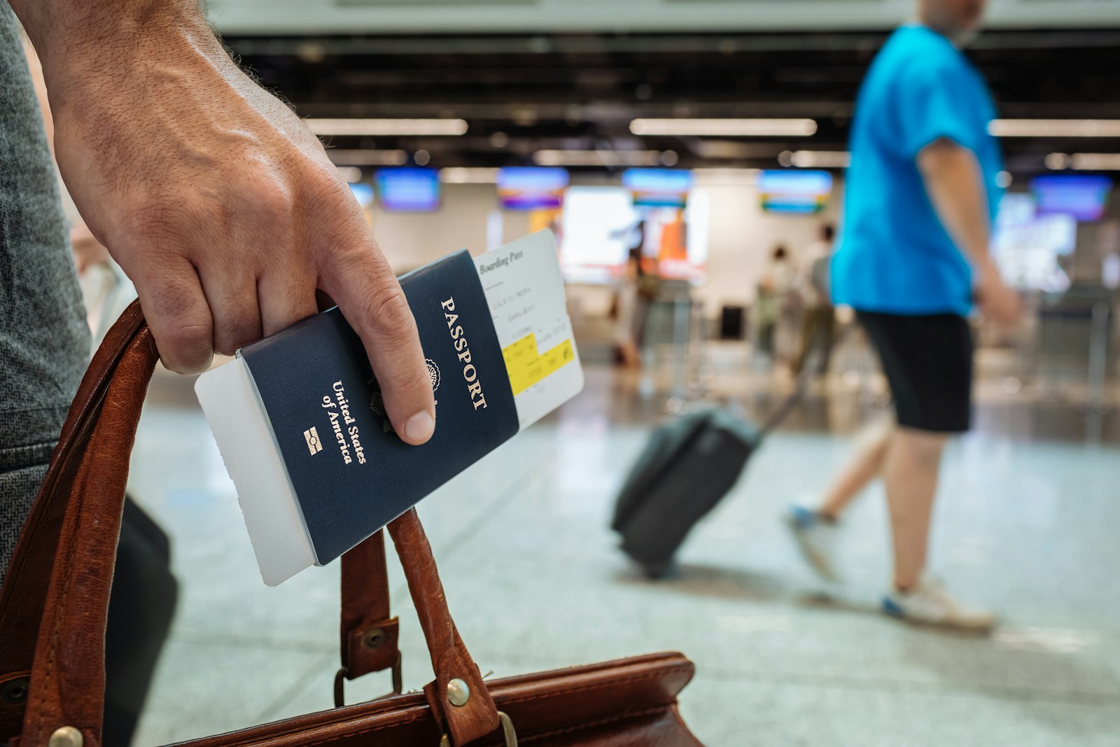 An immigration officer checks a foreign traveller’s passport